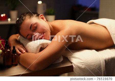 Nude woman relaxing in comfortable spa salon 76519870