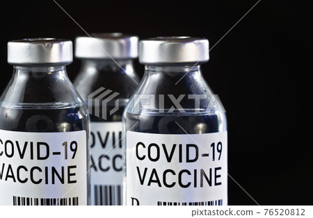 Coronavirus Covid-19 vaccine concept -  three glass vials on black table, closeup detail (own design - dummy barcode, not real product) 76520812