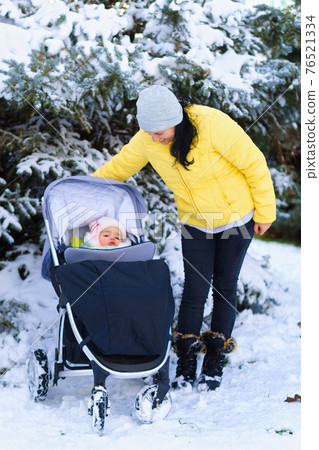 family portrait in the winter forest, mother and baby, bright snowy fir trees, beautiful nature 76521334