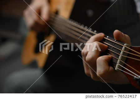 Man playing acoustic guitar, cover for online courses, learning at home. Man playing acoustic guitar, cover for online courses, learning at home. 76522417