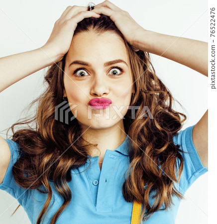 young pretty teenage hipster girl posing emotional happy smiling on white background, lifestyle people concept closeup young pretty teenage hipster girl posing emotional happy smiling on white background, lifestyle people concept closeup 76522476
