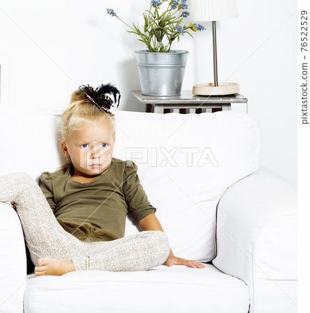 little cute blond girl at home interior happy smiling close up, lifestyle people concept 76522529