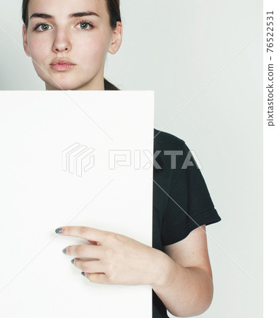 young pretty brunette girl with placard shit copyspace on white background wearing business costume student young pretty brunette girl with placard shit copyspace on white background wearing business costume student 76522531