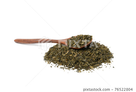 pile of dry green tea and brown wooden spoon pile of dry green tea and brown wooden spoon 76522804