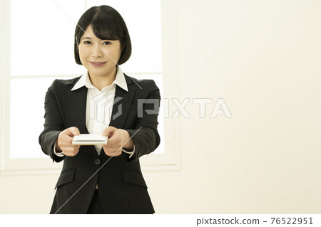 年輕女子穿著西裝展示名片(正面) 年輕女子穿著西裝展示名片(正面) 76522951