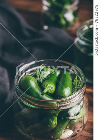 Canned Jalapeno Peppers, Garlic And Dill in Glass Jars 76522978