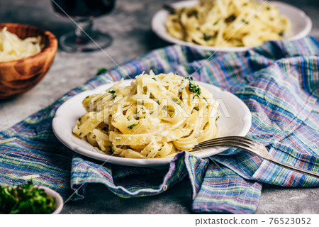 Portion of Fettuccine Pasta with Alfredo Sauce Portion of Fettuccine Pasta with Alfredo Sauce 76523052