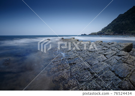 Unusual rock formations turbidites at beautiful seashore in the blue evening, Basque Country Unusual rock formations turbidites at beautiful seashore in the blue evening, Basque Country 76524434