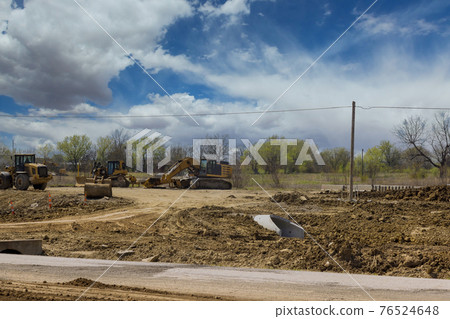Heavy excavator working during road works, construction of the new road Heavy excavator working during road works, construction of the new road 76524648