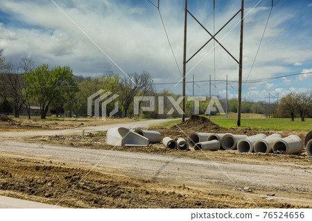 Main road construction drainage system on concrete manholes are installed at constructed for draining stormwater 76524656