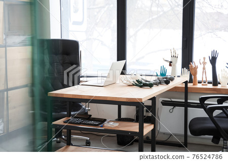 Table with laptop at the office of engineers who developing artificial limbs 76524786