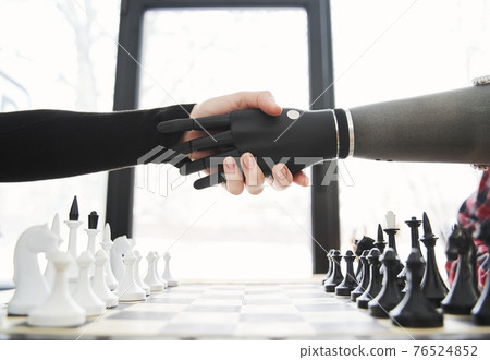 Client or patient doing handshake with bionic limb while sitting 76524852