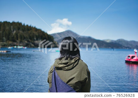 A woman staring at Lake Ashi A woman staring at Lake Ashi 76526928