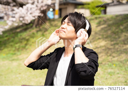 Men enjoying music content Men enjoying music content 76527114