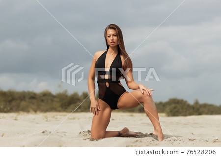 Gorgeous young female crawling on beach Gorgeous young female crawling on beach 76528206