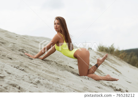 Sexy female in bright swimsuit on beach beach 76528212