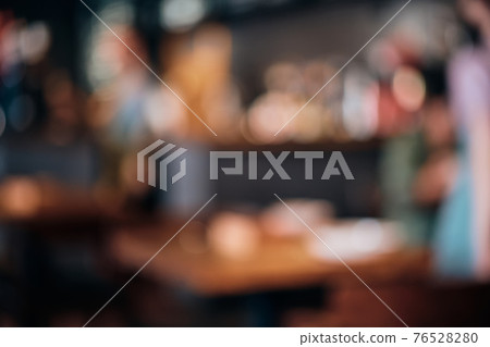 Coffee shop blur background with bokeh lights. Blurred outlines of bar and tables, dim lights 76528280
