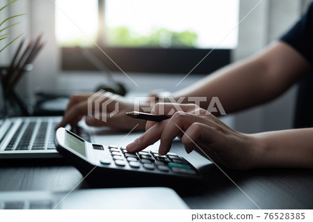 Businessman accountant or financial expert analyze business report graph and finance chart at corporate office. Concept of finance economy, banking business and stock market research 76528385