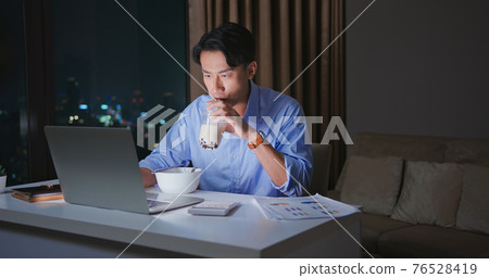 businessman overtime work at home 76528419
