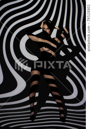Fashion portrait of young lady with shadow on her body Fashion portrait of young lady with shadow on her body 76528801