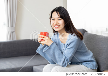 放鬆在沙發的一個少婦 76528857