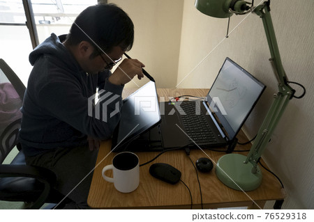 A man drawing an illustration with a pen tab A man drawing an illustration with a pen tab 76529318