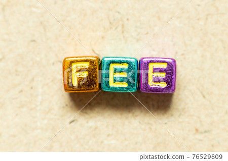 Metallic color alphabet letter block in word fee on wood background Metallic color alphabet letter block in word fee on wood background 76529809