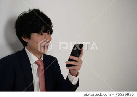Businessman smartphone smile 76529956
