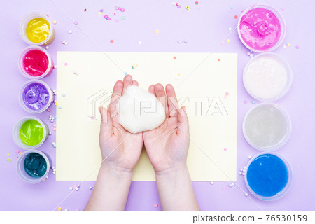 Multi-colored slimes on the table. The child plays with slimes. Play toy - slime Multi-colored slimes on the table. The child plays with slimes. Play toy - slime 76530159