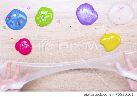 Multi-colored slimes on the table. The child plays with slimes. Play toy - slime Multi-colored slimes on the table. The child plays with slimes. Play toy - slime 76530161