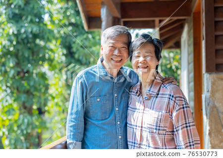 retired couple smiling at you retired couple smiling at you 76530773