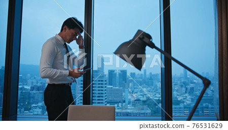 worried asian businessman in office worried asian businessman in office 76531629