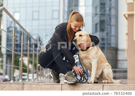 Portrait of a woman with her beautiful dog 76532400