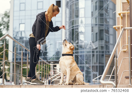 Portrait of a woman with her beautiful dog Portrait of a woman with her beautiful dog 76532408
