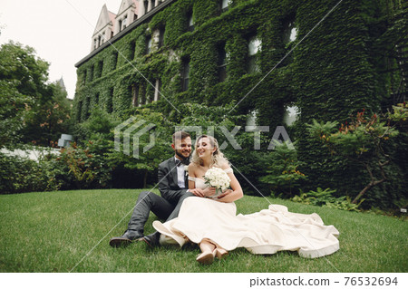 wedding couple walking in the park near the university in chicago wedding couple walking in the park near the university in chicago 76532694
