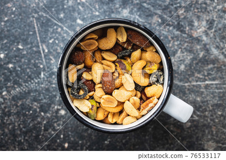 Mix of salted nuts in cup. Mix of salted nuts in cup. 76533117