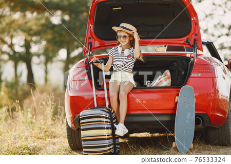 Child sitting in a car trunk 76533324