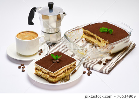 Traditional Italian Tiramisu dessert in glass baking dish, portion on plate and cup of coffee isolated on white background 76534909