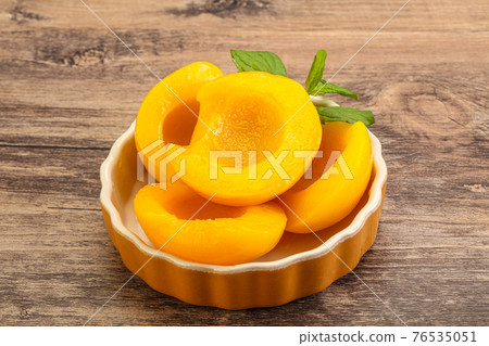 Sweet ripe canned peaches with mint 76535051