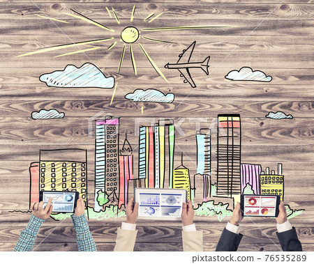 Top view of businesspeople sitting at table and using gadgets Top view of businesspeople sitting at table and using gadgets 76535289