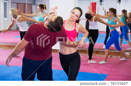 Woman training self-defence moves Woman training self-defence moves 76535607