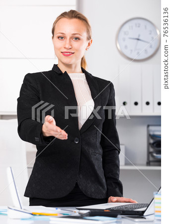 Smiling female in black suit 76536136