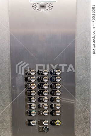 Shiny metal panel with round buttons with floor numbers 76536593