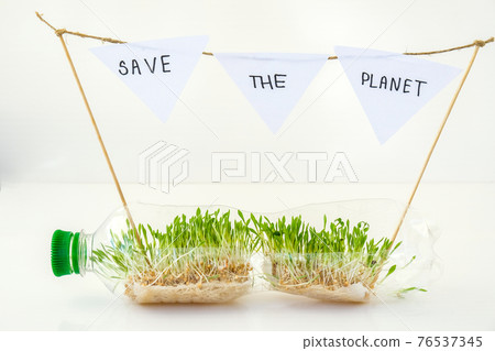 SAVE THE PLANET Young green plants in plastic bottle. Ecology and Environmental conversation. Earth day concept. Global pollution of the planet. Seedling SAVE THE PLANET Young green plants in plastic bottle. Ecology and Environmental conversation. Earth day concept. Global pollution of the planet. Seedling 76537345