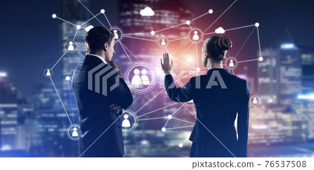 Concept of social connection and networking against night city view and partners working in cooperation Concept of social connection and networking against night city view and partners working in cooperation 76537508