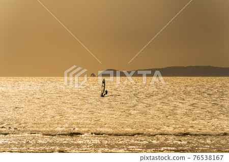 Windsurfing at dusk Windsurfing at dusk 76538167