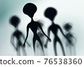 Silhouettes of spooky aliens and bright light on behind them 76538360