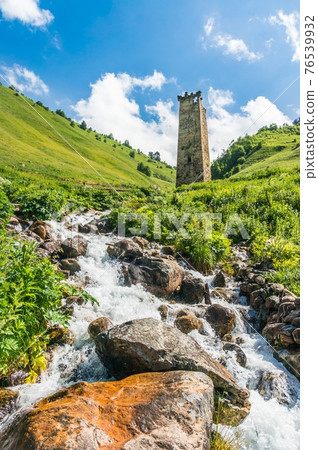 Mountain stream and watch tower in the village Adishi, Georgia 76539932