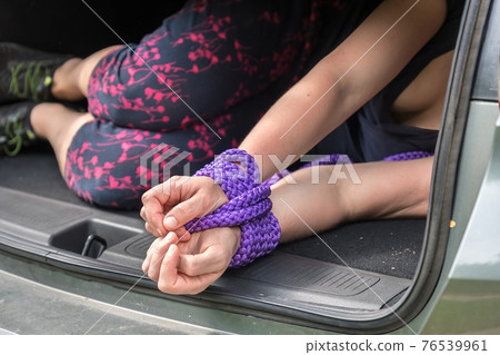 Woman with tied hands inside car trunk - kidnapping 76539961