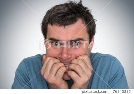 Nervous man biting his nails - nervous breakdown 76540285